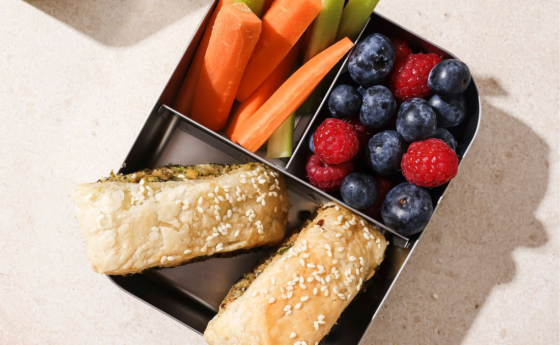 PACKD veggie rolls in a pack up tray with fruit and salad sides