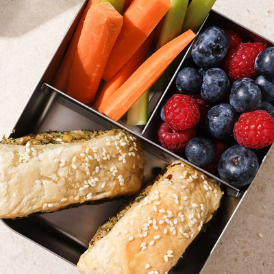 PACKD veggie rolls in a pack up tray with fruit and salad sides