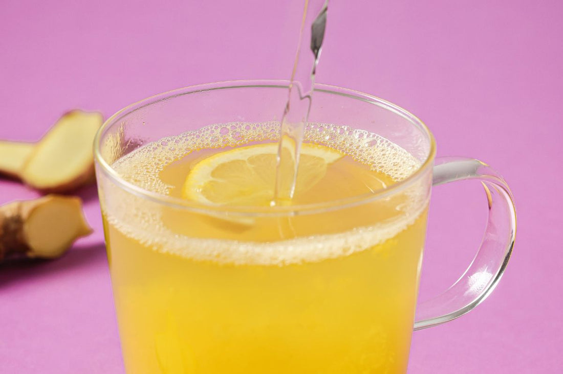 Glass cup with a PACKD Immunity Wellness Hottie drink being poured