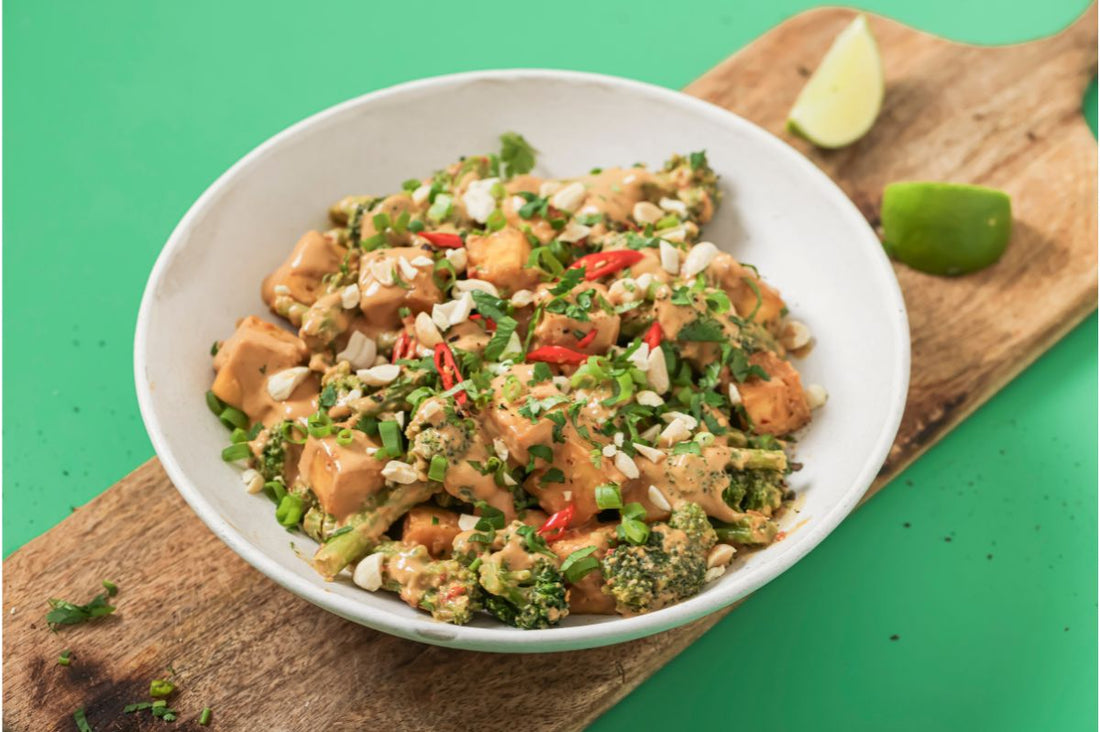 PACKD Vegan Peanut Butter Tofu Bowl in a bowl that is sat on a chipping board