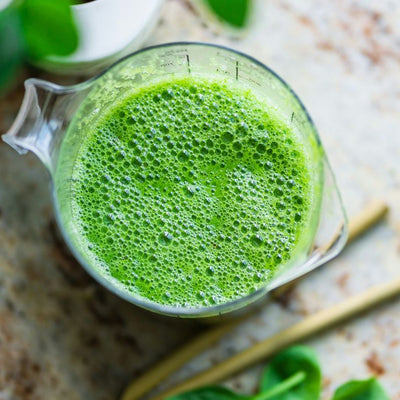 Jug with a gut healthy probiotic green smoothie, viewed from above.