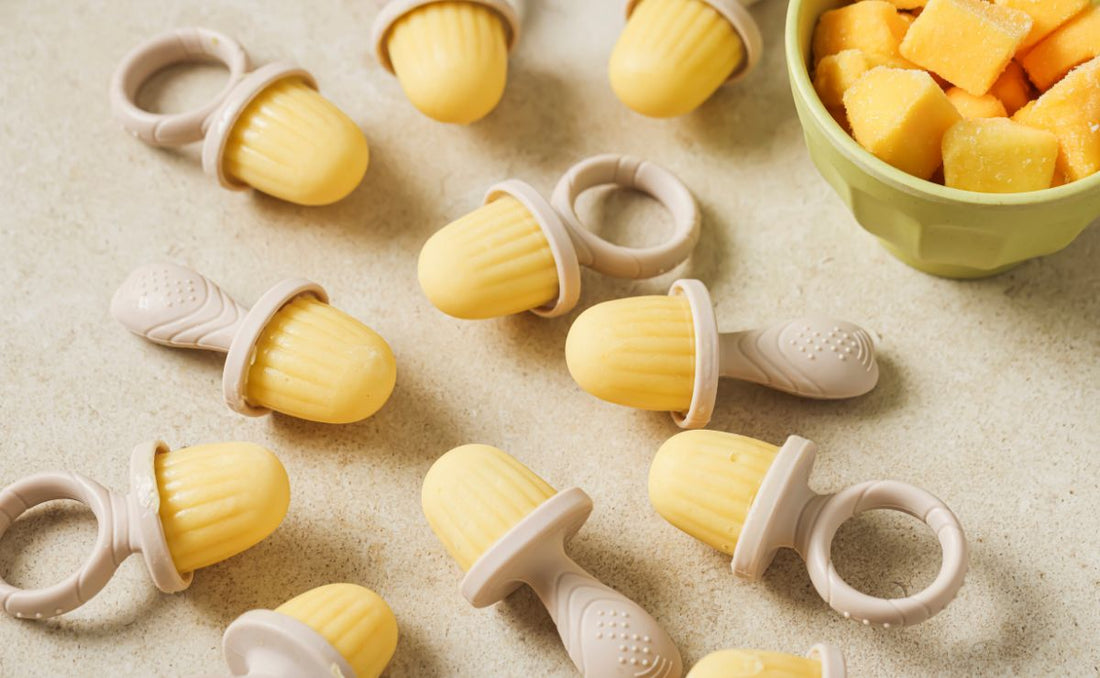 Homemade baby teething popsicles made with PACK'D Organic Frozen Mango and Greek yogurt, set in a mini popsicle mould