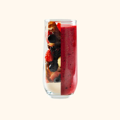 Dark Berry Immunity Smoothie glass showing half fruit and half mixed smoothie