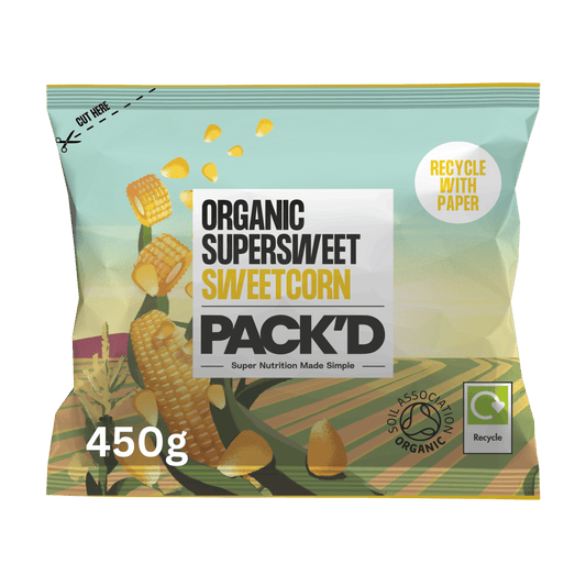 A 450g bag of PACK'D Organic SuperSweet Sweetcorn, featuring a light teal and green design with illustrations of corn ears, a white central label, and certification logos including Soil Association Organic.