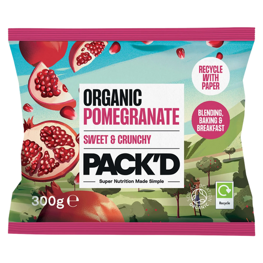 Front of PACK'D Organic Pomegranate 300g paper packaging. Illustration of sweet and crunchy frozen pomegranate seeds with Soil Association Organic certification logo. Text highlights usage for blending, baking and breakfast.